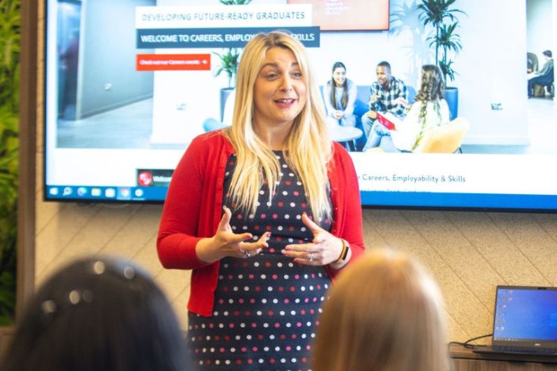 staff member talking to a room full of students